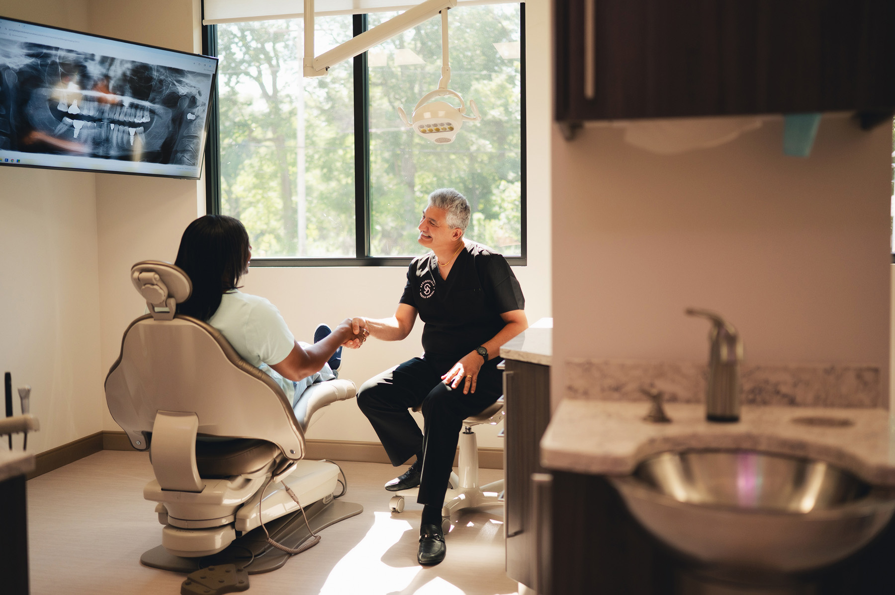 Dentist reviewing x-ray for restorative and implant treatment planning